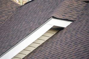 Home with brown asphalt roof shingles