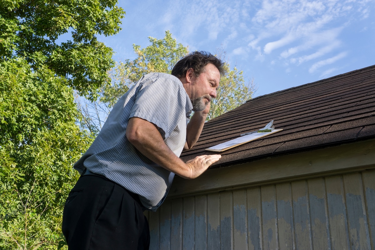 Insurance adjuster looking for hail damage.