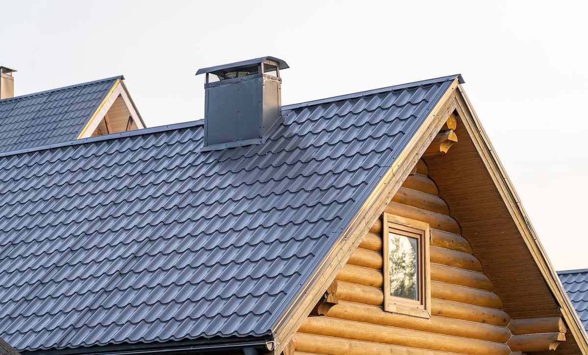 A close-up view of a wooden log cabin with a metal roof