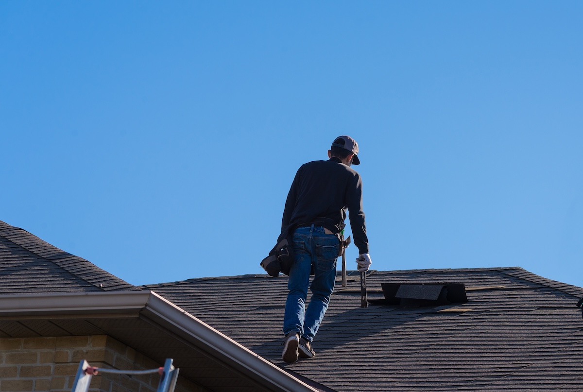 Roofer inspects roof damage